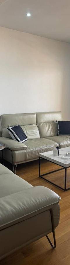 a living room with a couch and a table at Ithaki Phinikoudes Apartment No. 201 in Larnaka