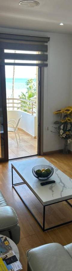 a living room with a couch and a coffee table at Ithaki Phinikoudes Apartment No. 201 in Larnaka