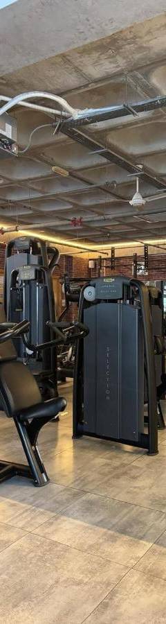 a gym with a bunch of equipment in a room at Ithaki Phinikoudes Apartment No. 201 in Larnaka