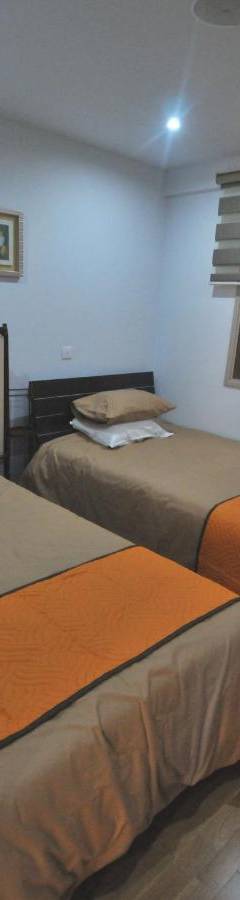 two beds in a room with a window at Ithaki Phinikoudes Apartment No. 201 in Larnaka