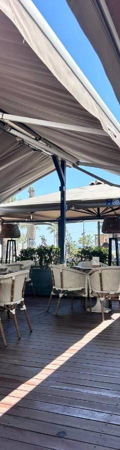 a patio with tables and chairs under a canopy at Alex Residence in Larnaka