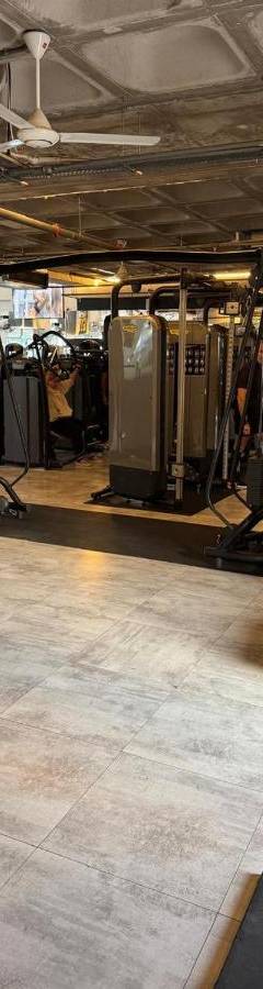 a room with a gym with a treadmill and a bench at Alex Residence in Larnaka