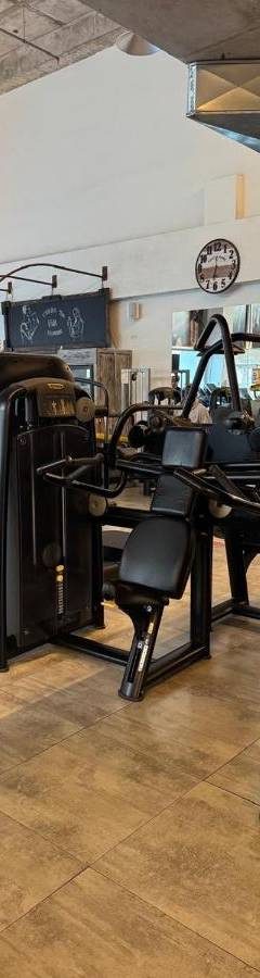 a store with a bunch of gym equipment in a room at Alex Residence in Larnaka