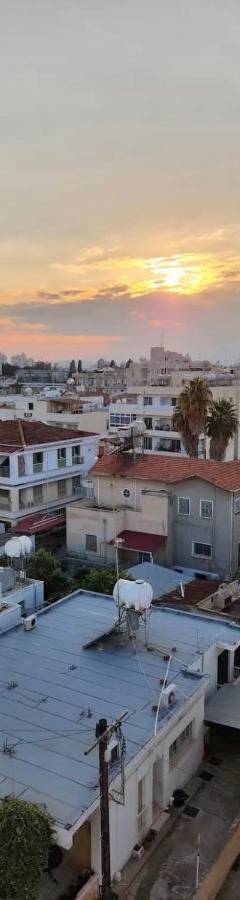an aerial view of a city at sunset at Alex Residence in Larnaka
