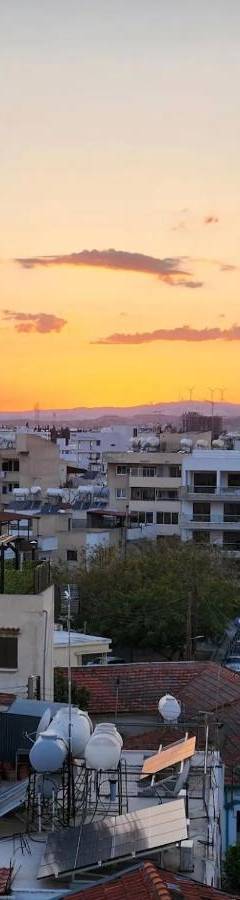 a view of a city at sunset at Alex Residence in Larnaka