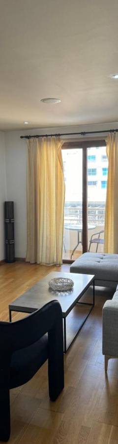 a living room with a couch and a table at Ithaki Phinikoudes Apartment No. 204 in Larnaka