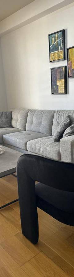 a living room with a couch and a table at Ithaki Phinikoudes Apartment No. 204 in Larnaka