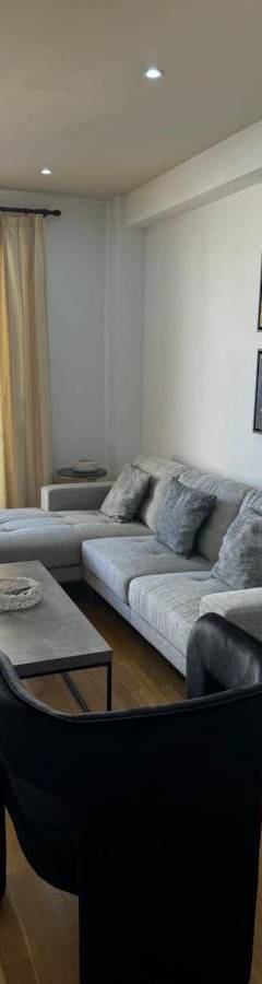 a living room with a couch and a table at Ithaki Phinikoudes Apartment No. 204 in Larnaka
