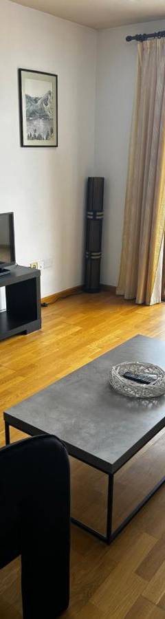 a living room with a couch and a coffee table at Ithaki Phinikoudes Apartment No. 204 in Larnaka