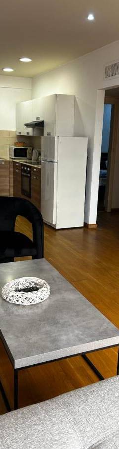 a living room with a couch and a table at Ithaki Phinikoudes Apartment No. 204 in Larnaka