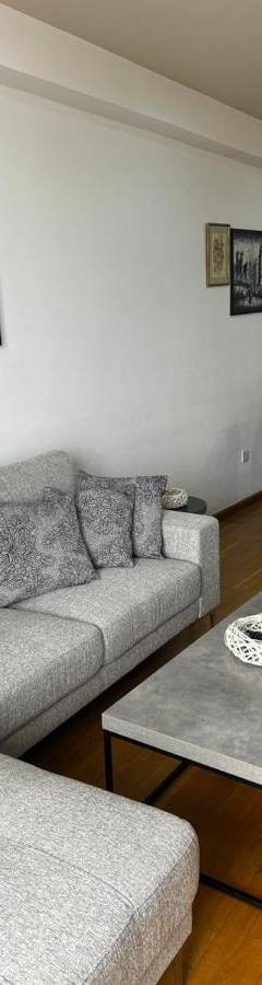 a living room with a couch and a table at Ithaki Phinikoudes Apartment No. 204 in Larnaka