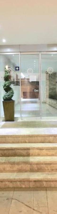 a lobby with stairs and potted plants at Ithaki Phinikoudes Apartment No. 204 in Larnaka