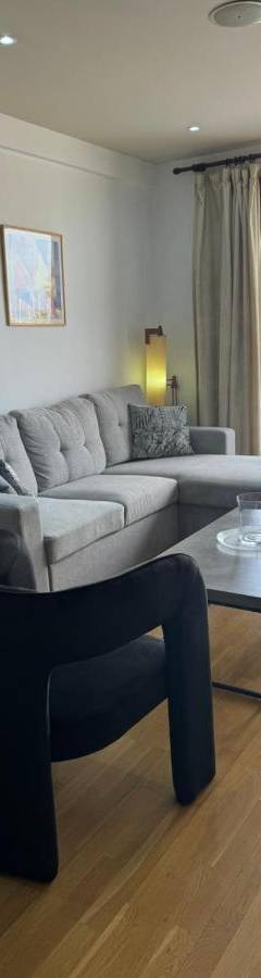 a living room with a couch and a table at Ithaki Phinikoudes Apartment No. 105 in Larnaka
