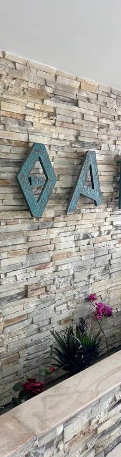 a brick wall with a sign that reads exit at Ithaki Phinikoudes Apartment No. 105 in Larnaka
