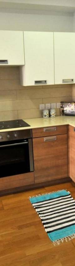 a kitchen with a white refrigerator and a washing machine at Ithaki Phinikoudes Apartment No. 105 in Larnaka