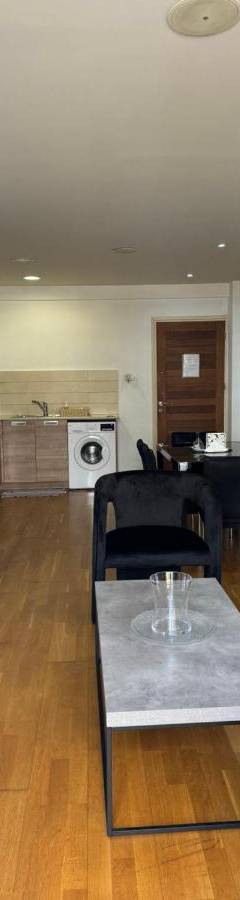 a living room with a couch and a table at Ithaki Phinikoudes Apartment No. 105 in Larnaka