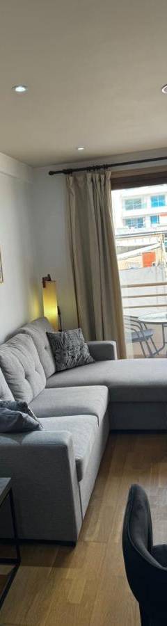 a living room with a couch and a table at Ithaki Phinikoudes Apartment No. 105 in Larnaka