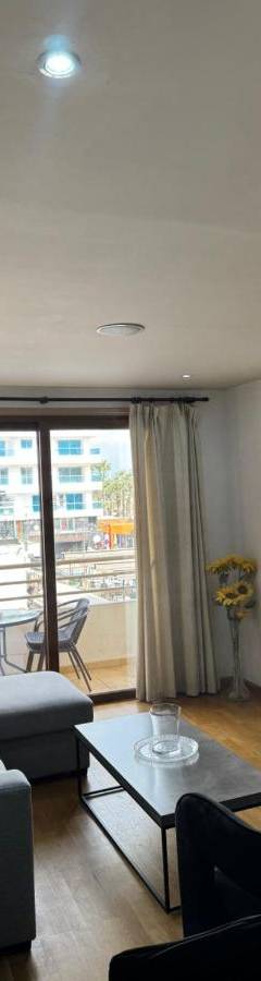 a living room with a couch and a table at Ithaki Phinikoudes Apartment No. 105 in Larnaka