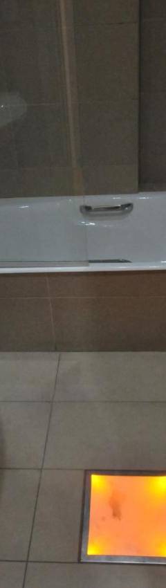 a bathroom with a sink and a tub and a toilet at Ithaki Phinikoudes Apartment No. 105 in Larnaka