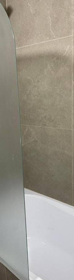a shower with a glass door in a bathroom at Alex Beach Apartment 34 in Larnaka