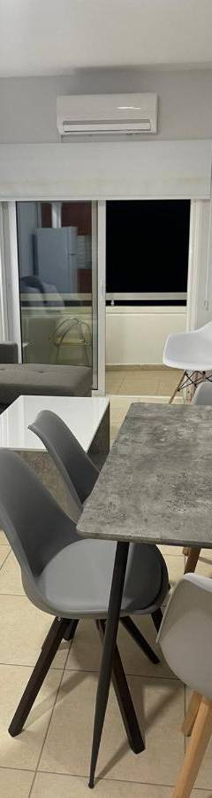 a living room with a table and chairs and a couch at Alex Beach Apartment 34 in Larnaka