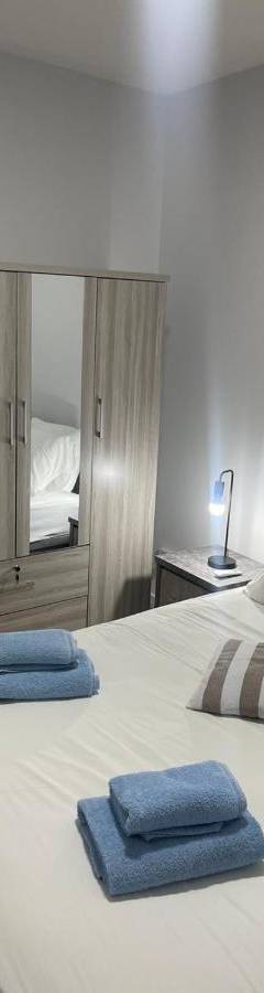 a bedroom with a large bed with two towels on it at Alex Beach Apartment 34 in Larnaka