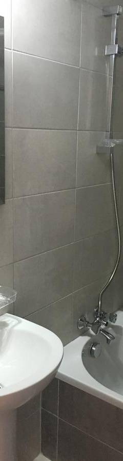 a bathroom with a sink and a shower and a tub at Alex Beach Apartment 51 in Larnaka
