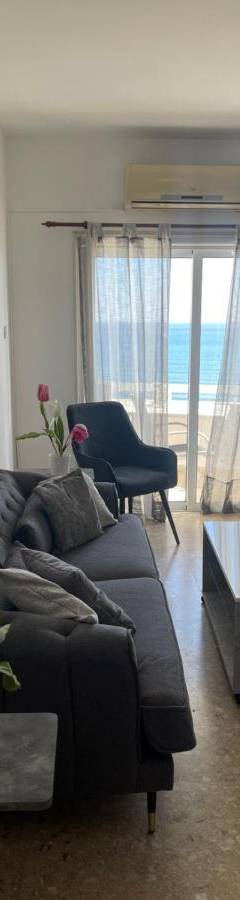 a living room with a couch and a table at Alex Beach Apartment 51 in Larnaka