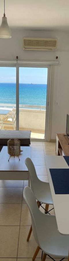 a living room with a couch and a table at Alex Beach Apartment 31 in Larnaka