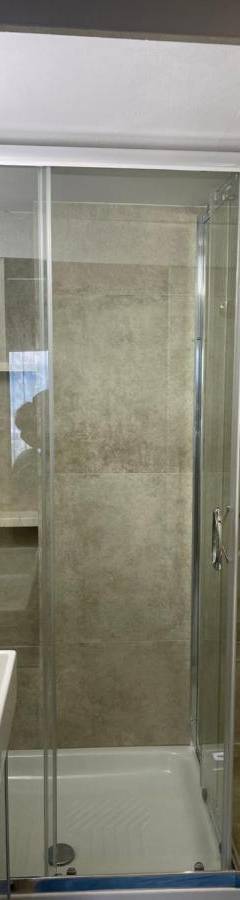 a bathroom with a shower and a sink and a toilet at Alex Beach Apartment 31 in Larnaka