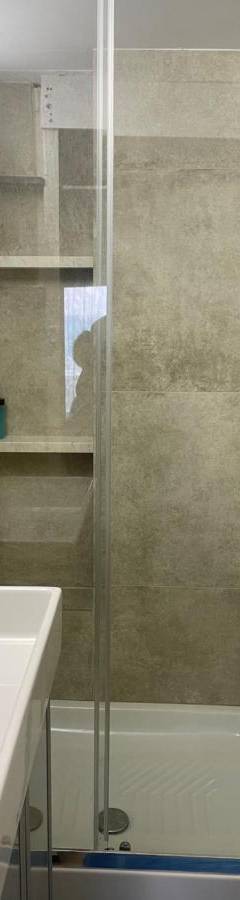 a bathroom with a shower and a sink and a tub at Alex Beach Apartment 31 in Larnaka
