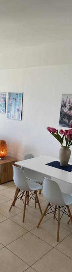 a living room with a white table and chairs at Alex Beach Apartment 31 in Larnaka