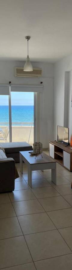 a living room with a couch and a table at Alex Beach Apartment 31 in Larnaka