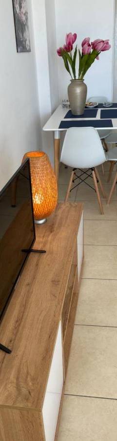 a tv sitting on a wooden table in a living room at Alex Beach Apartment 31 in Larnaka