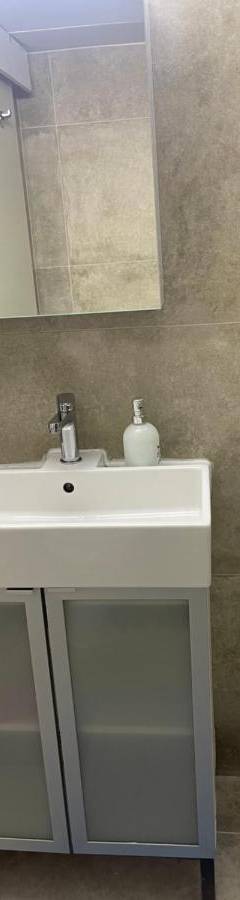 a bathroom with a sink and a shower at Alex Beach Apartment 31 in Larnaka