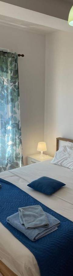 a bedroom with a bed with two towels on it at Alex Beach Apartment 31 in Larnaka