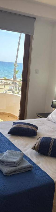 a bedroom with a bed with a view of the ocean at Ithaki Phinikoudes Apartment No. 202 in Larnaka