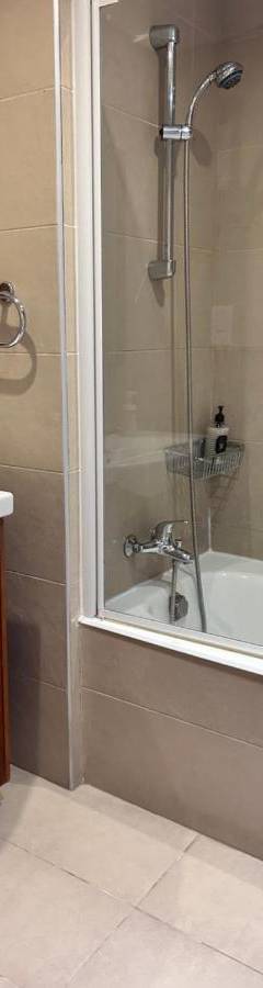 a bathroom with a shower and a sink and a tub at Ithaki Phinikoudes Apartment No. 202 in Larnaka