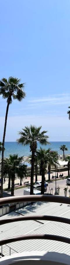 a view of the beach from the balcony of a resort at Ithaki Phinikoudes Apartment No. 202 in Larnaka