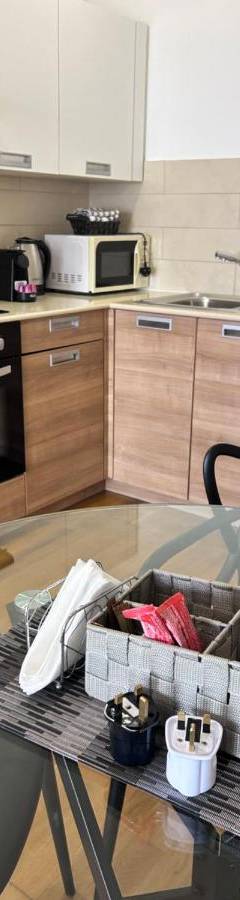 a kitchen with a glass table and a counter top at Ithaki Phinikoudes Apartment No. 202 in Larnaka