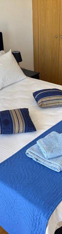 a bed with two towels and two pillows on it at Ithaki Phinikoudes Apartment No. 202 in Larnaka