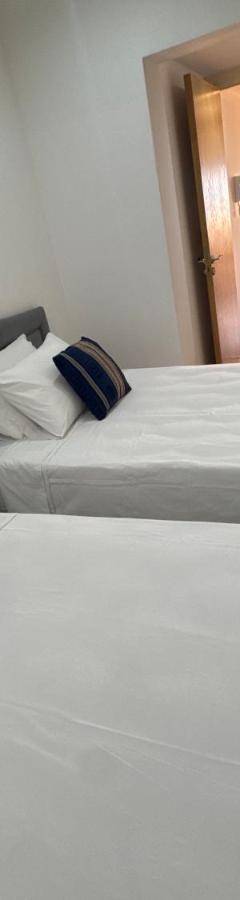 two twin beds in a room with a mirror at Ithaki Phinikoudes Apartment No. 202 in Larnaka