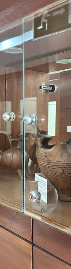 a display case with vases on display in a museum at Ithaki Phinikoudes Apartment No. 202 in Larnaka