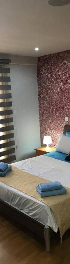 a bedroom with a bed with two towels on it at Ithaki Phinikoudes Apartment No. 207 in Larnaka