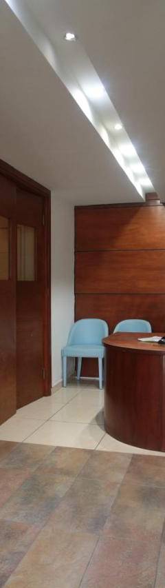 a man sitting at a desk in an office with a laptop at Ithaki Phinikoudes Apartment No. 207 in Larnaka