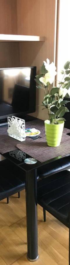 a black table with black chairs and a television at Ithaki Phinikoudes Apartment No. 207 in Larnaka
