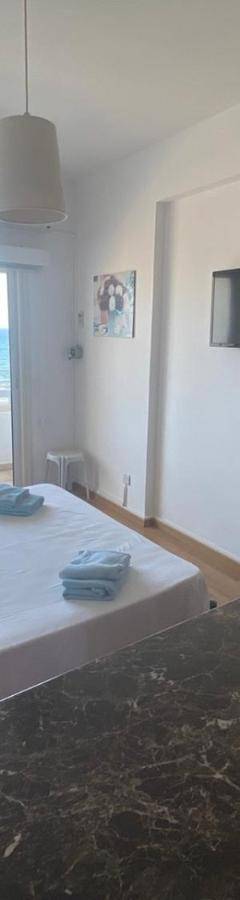 a bedroom with a bed with a view of the ocean at Alex Beach Apartment 33 in Larnaka