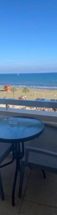 a balcony with a table and chairs and a view of the beach at Alex Beach Apartment 33 in Larnaka