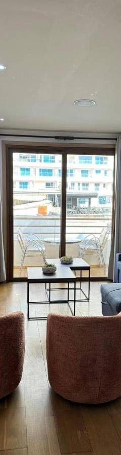 a living room with a blue couch and chairs at Ithaki Phinikoudes Apartments No. 106 in Larnaka