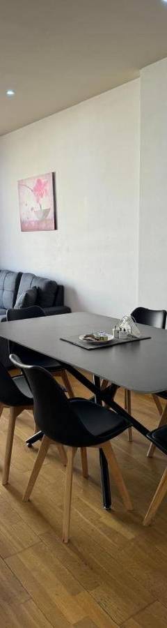 a dining room with a table and chairs and a couch at Ithaki Phinikoudes Apartments No. 106 in Larnaka
